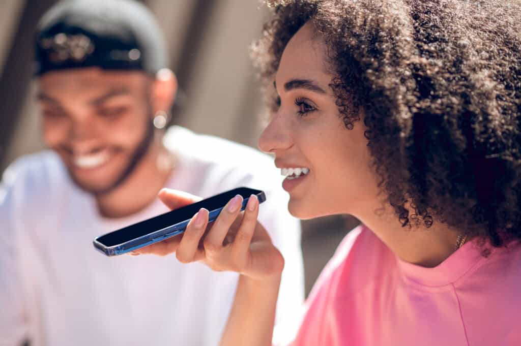 Voice search optimization helps a business get seen by a couple using voice search to find a place to eat